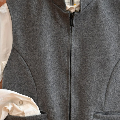 View of Schaefer grey wool vest with zip front, pockets, and adjustable back belt