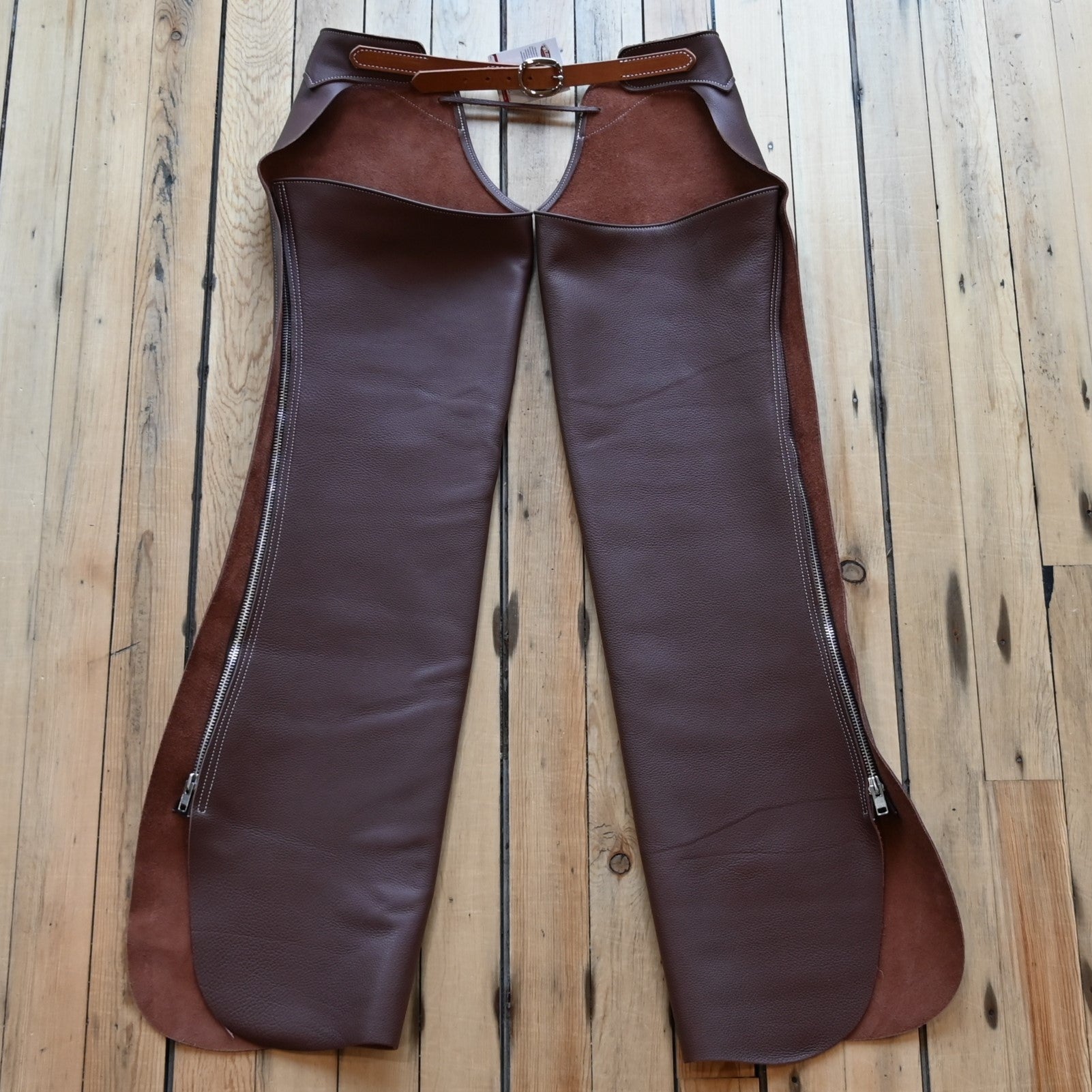 View of Weaver Shotgun Full Grain Chaps in brown oil-tanned leather with adjustable closures