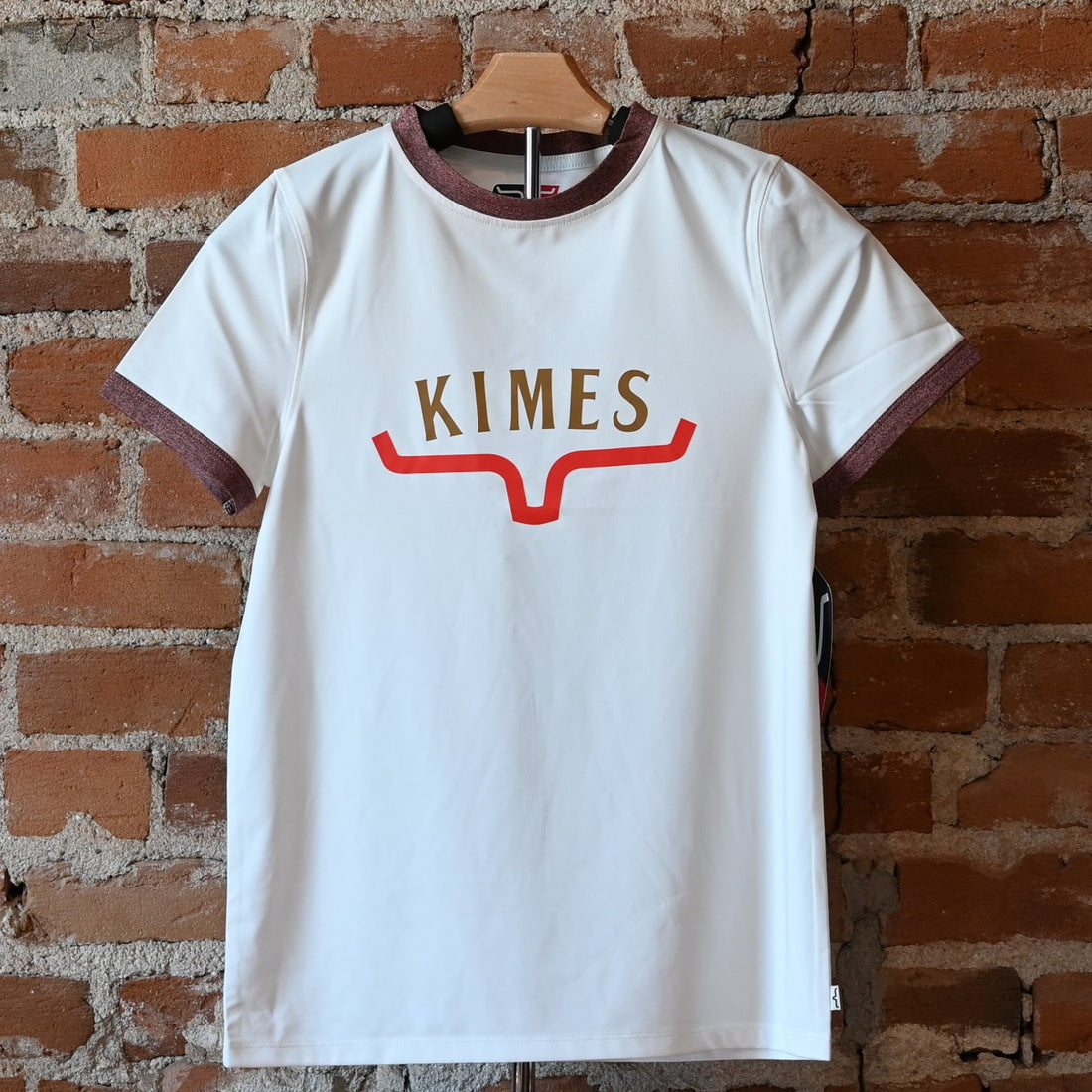 View of Kimes Ranch Ladies Tech T-Shirt in Natural, featuring a straight fit and heat transfer logo