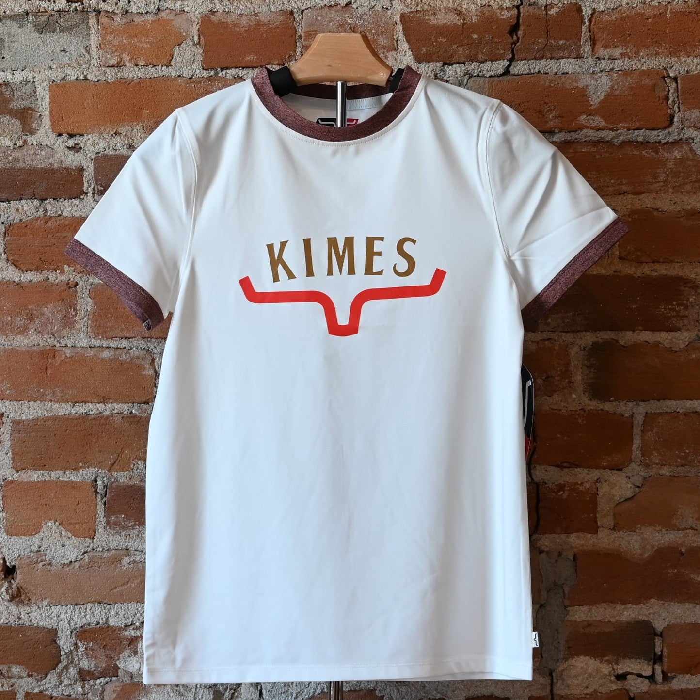 View of Kimes Ranch Ladies Tech T-Shirt in Natural, featuring a straight fit and heat transfer logo
