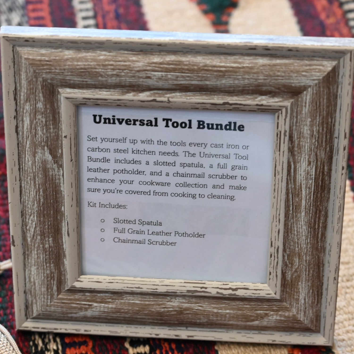 View of Smithey Ironware Universal Tool Bundle: slotted spatula, leather potholder, and chainmail scrubber 