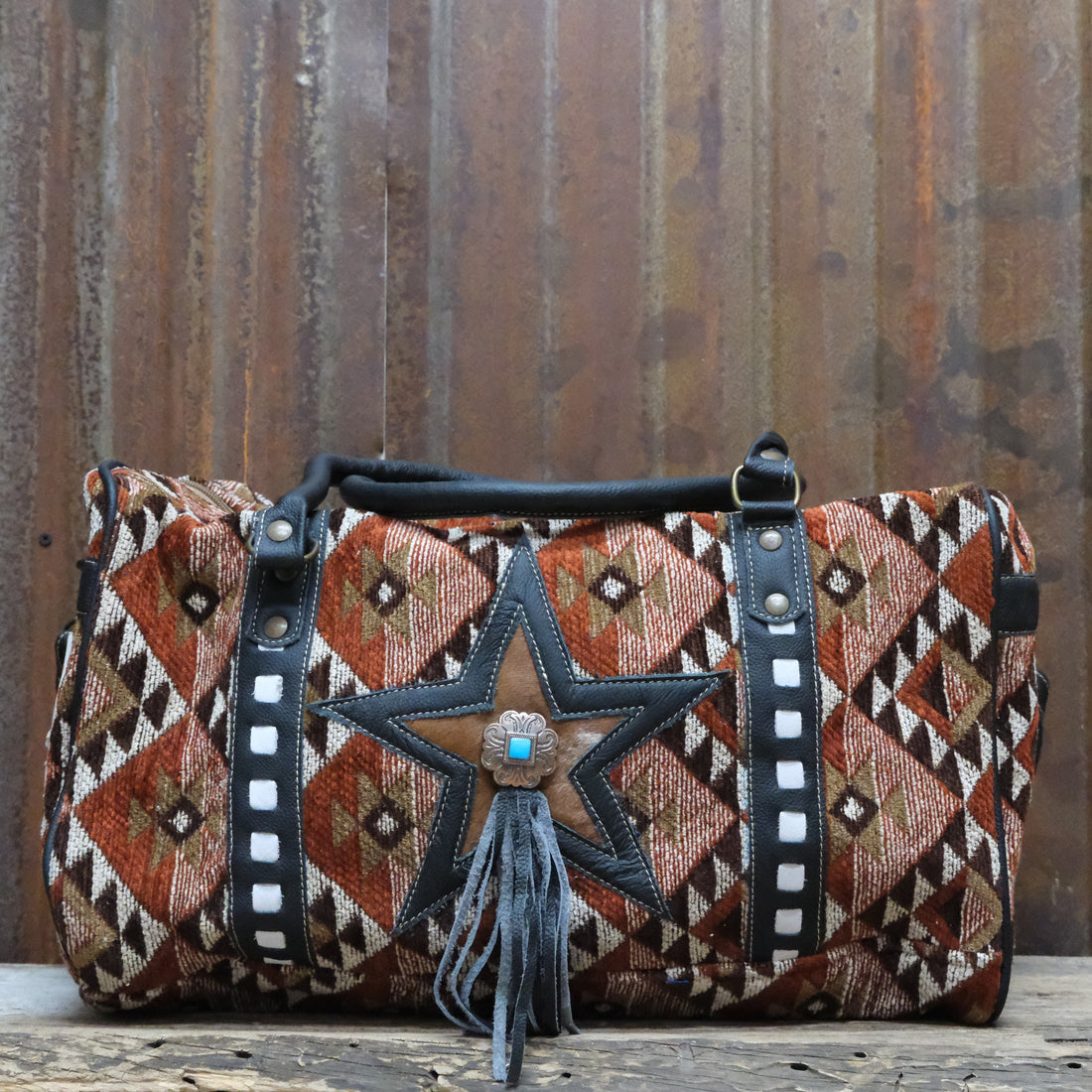 American Darling rust star canvas duffel bag with leather trim and turquoise concho
