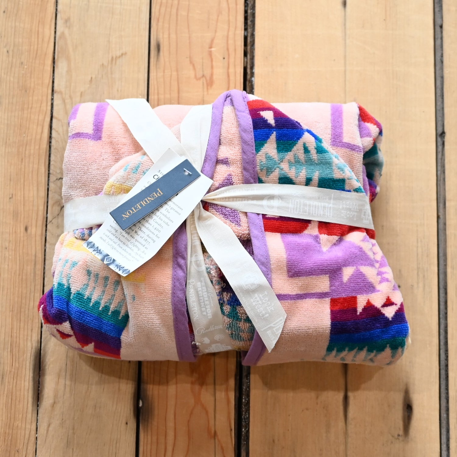View of Pendleton pink child-sized hooded towel with Chief Joseph jacquard pattern and absorbent terry lining