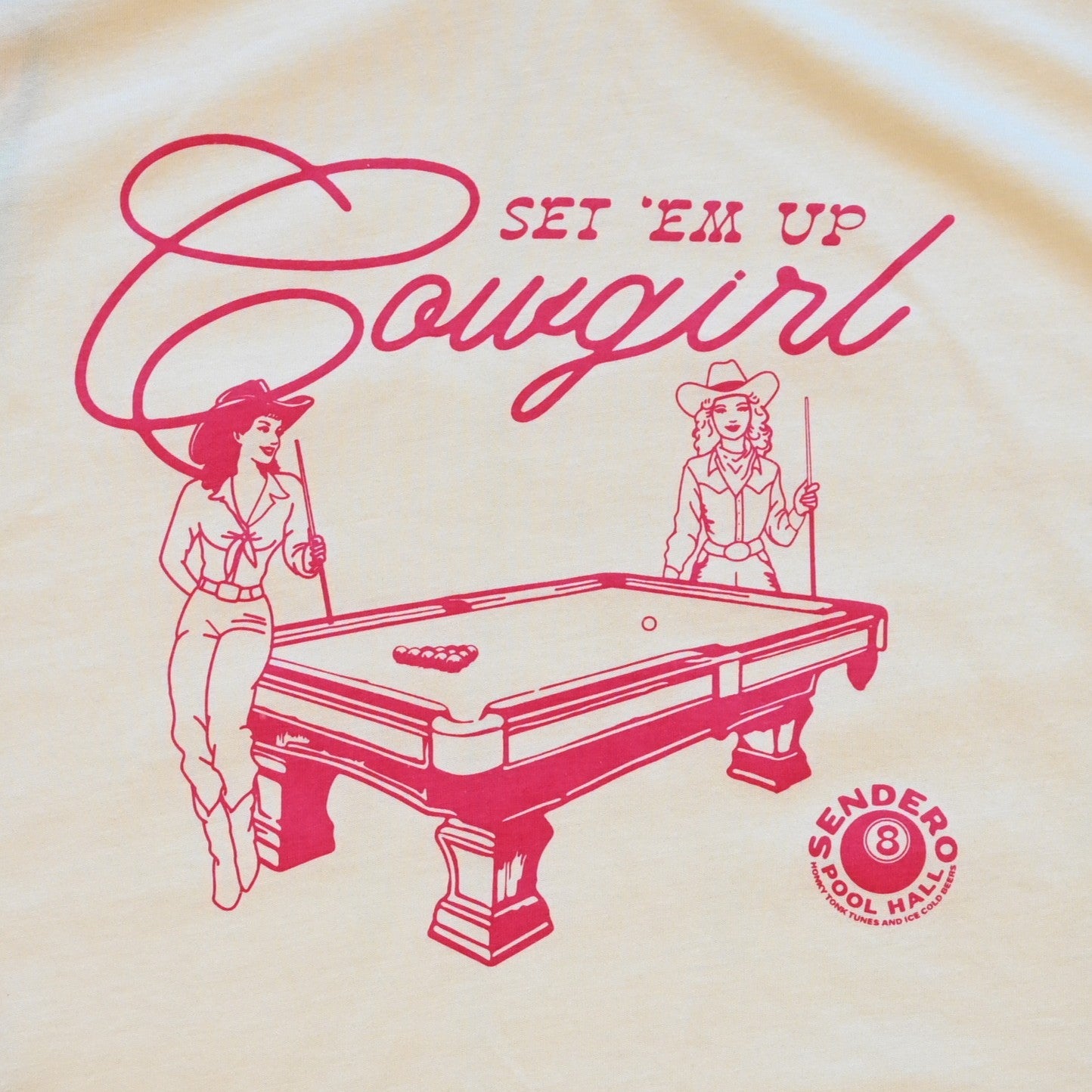 Ladies cream boxy tee by Sendero with two cowgirls playing pool and “Set ’Em Up Cowgirl” text