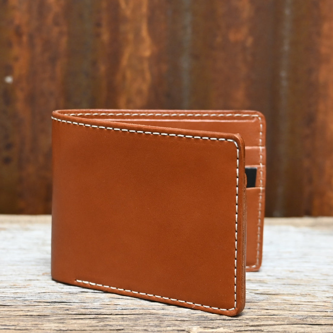 View of Filson Leather Bi-Fold Wallet in Tan featuring six card slots and a cash compartment