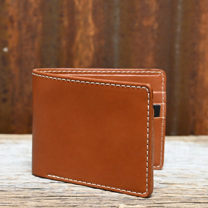 View of Filson Leather Bi-Fold Wallet in Tan featuring six card slots and a cash compartment