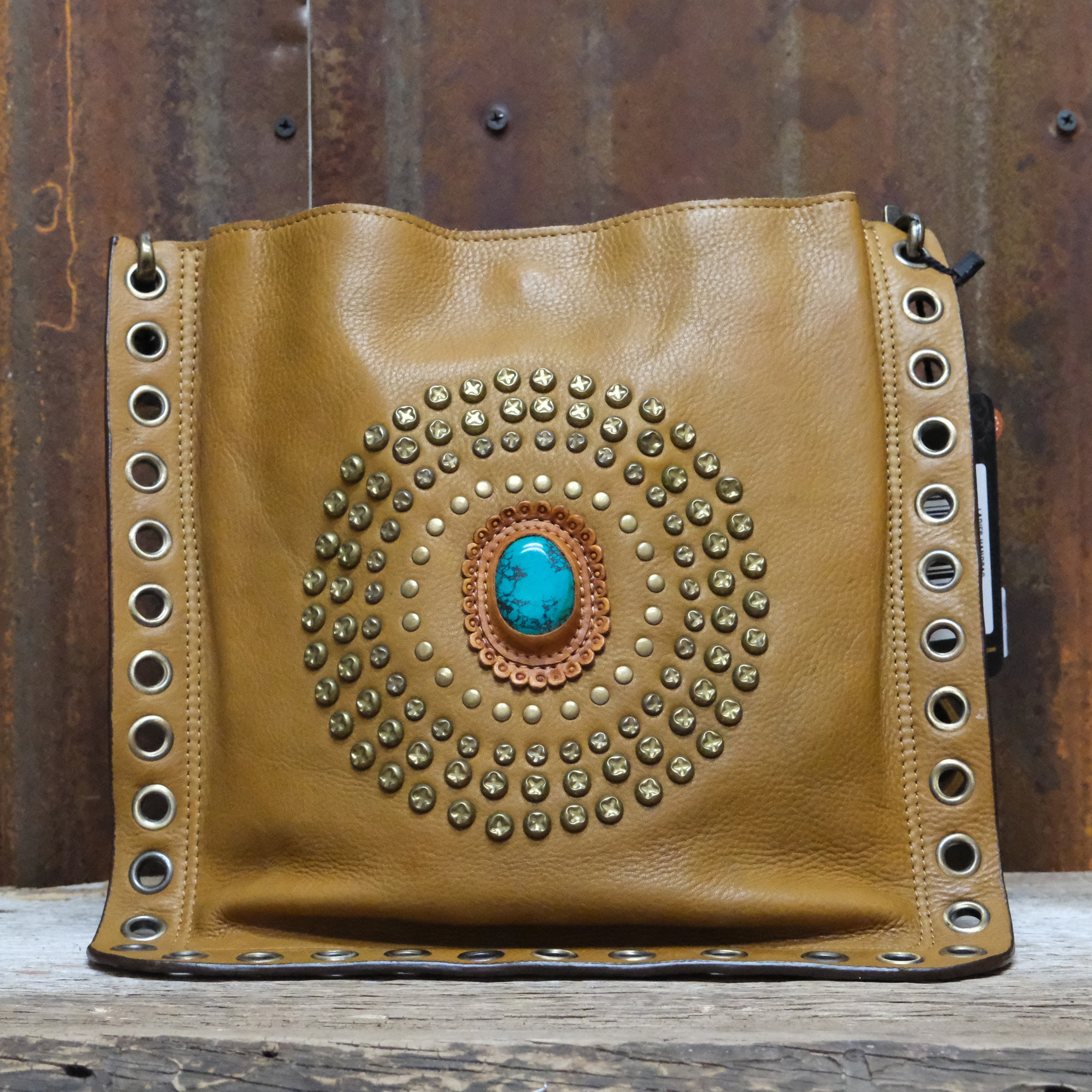 American Darling leather crossbody bag with studded circle and turquoise concho