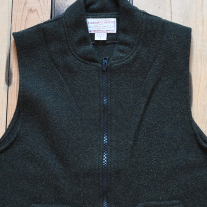 Forest green Filson Mackinaw Wool Vest Liner with zip-front, hand-warmer pockets, standing collar, and drawcord waist
