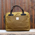 View of Filson Tin Cloth Compact Briefcase in Dark Tan, showcasing its durable waxed cotton exterior, leather handles, and padded laptop compartment