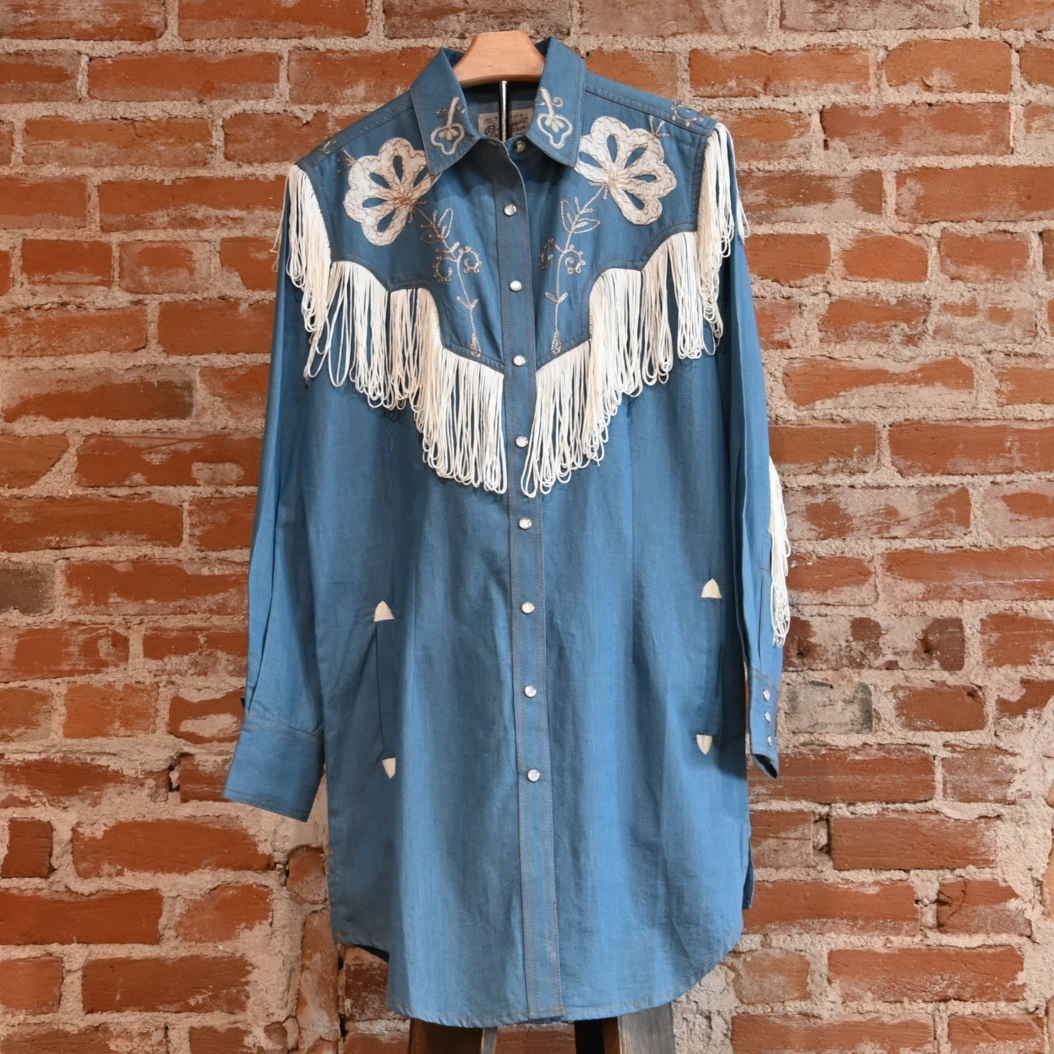 View of Rockmount ladies denim Western dress with fringe and floral embroidery