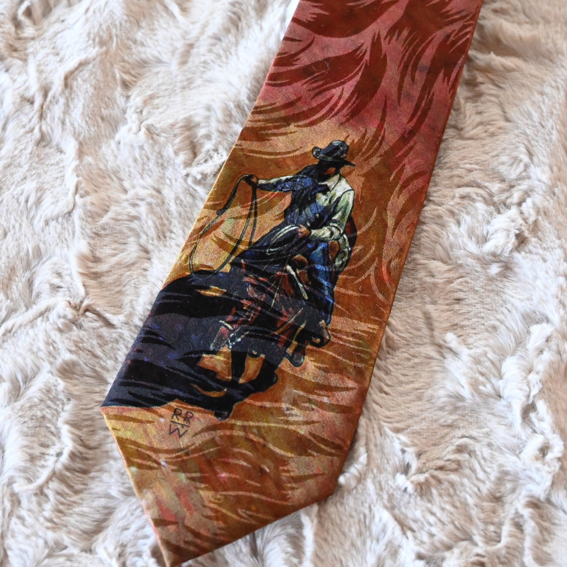 View of Silk necktie with cowboy on horseback roping, artwork by Howard Post