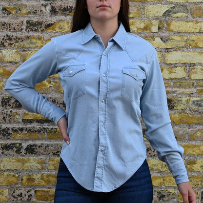View of Blue Blanket ladies light denim Western shirt with pearl snaps, curved hem, and yoke