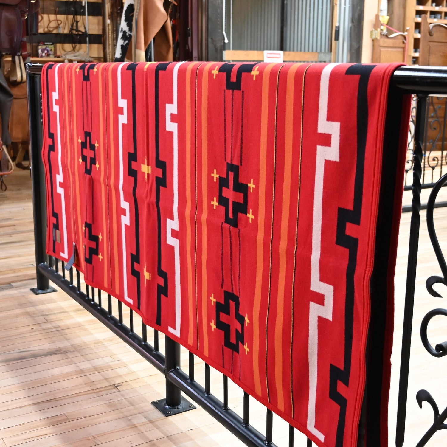 View of Red Pendleton robe blanket with geometric jacquard pattern and felt binding