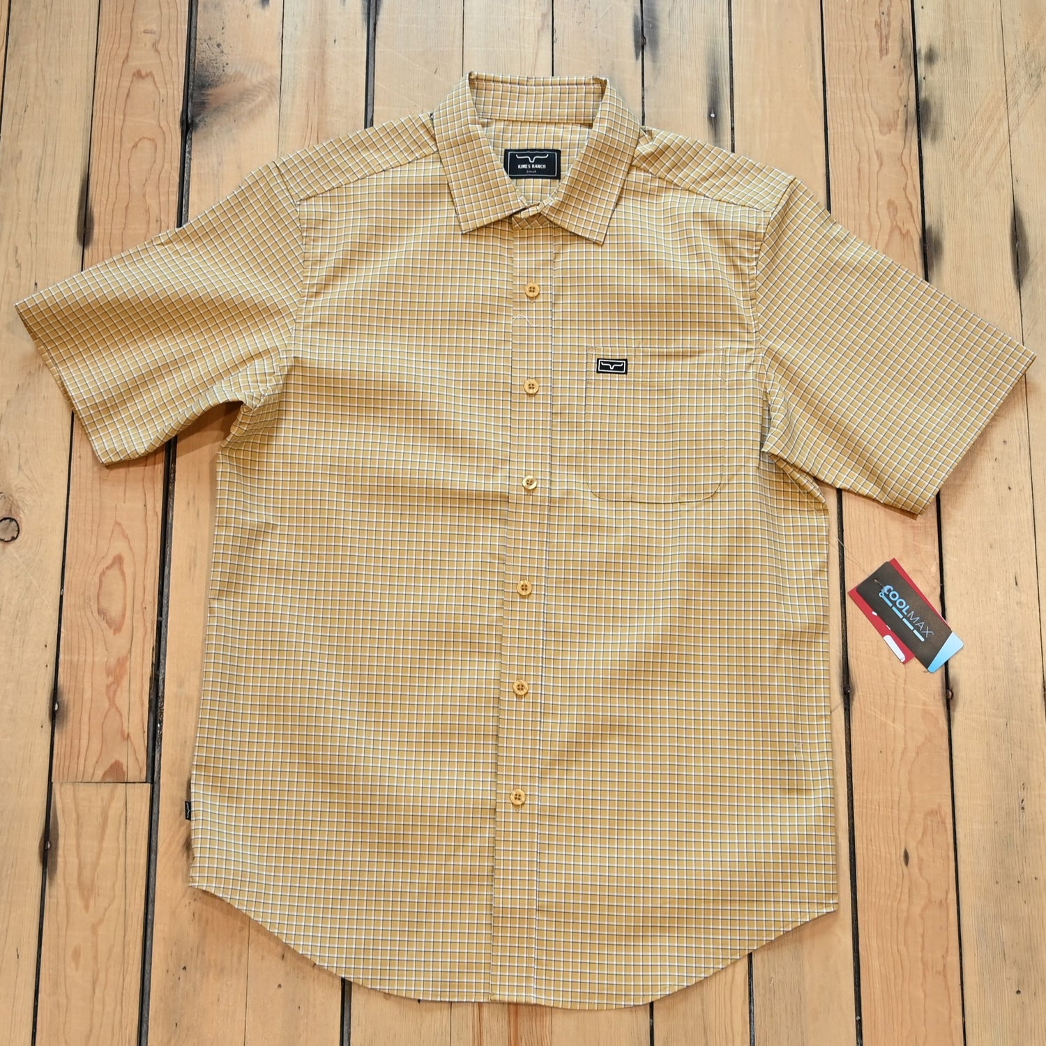 View of Kimes Ranch MC Cooper Short Sleeve Button-Up Shirt in Gold, featuring a grid plaid pattern and snap button front