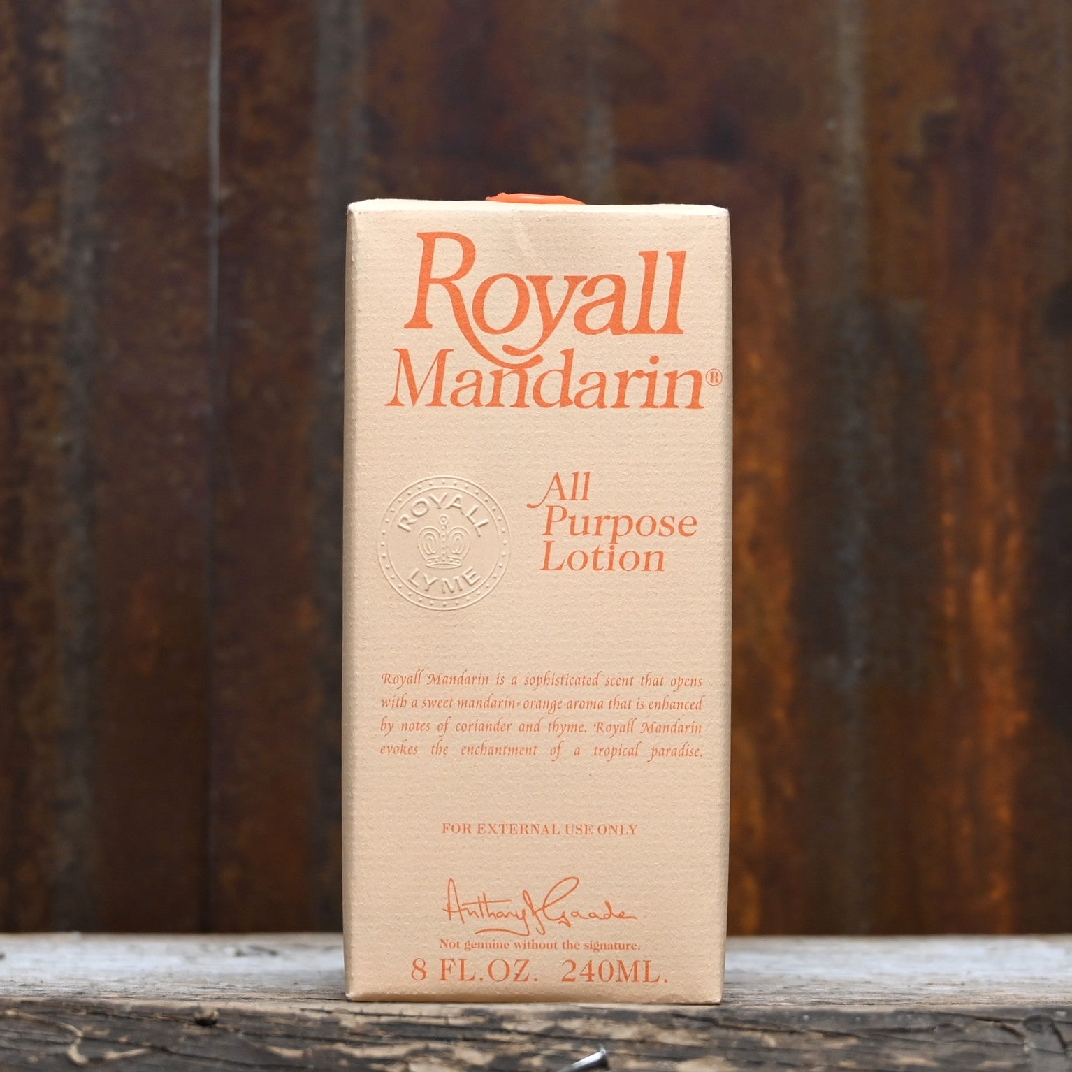 Royall Mandarin 8 oz bottle of all-purpose lotion and splash cologne in orange glass with gold cap