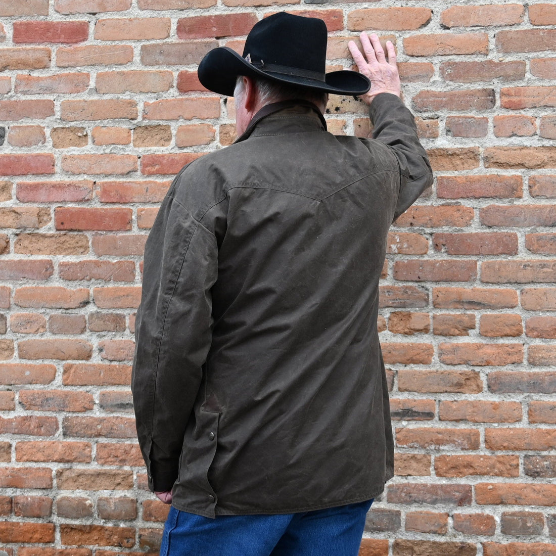 View of Schaefer oak waxed canvas High Plains Drifter jacket with leather collar and multiple pockets