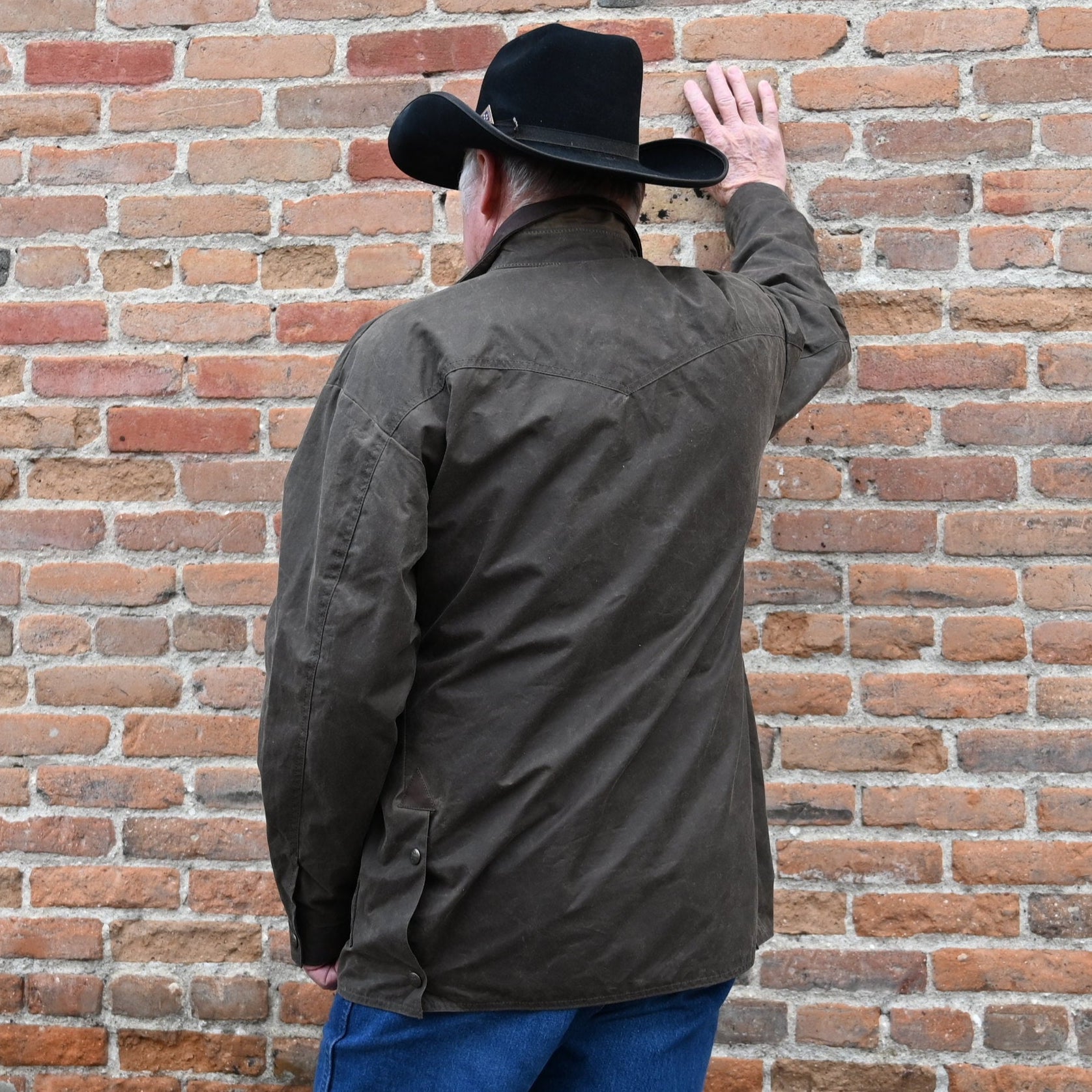 View of Schaefer oak waxed canvas High Plains Drifter jacket with leather collar and multiple pockets