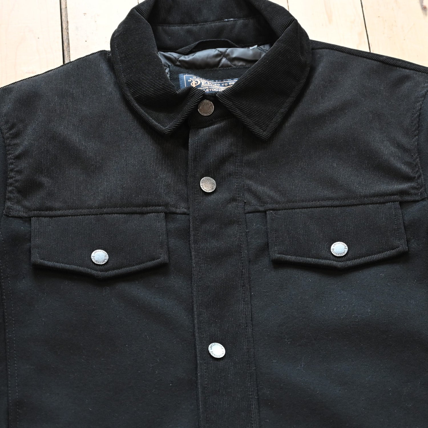 View of Pendleton Men’s Timberline shirt jacket in black wool blend with quilted lining and corduroy shoulder detail