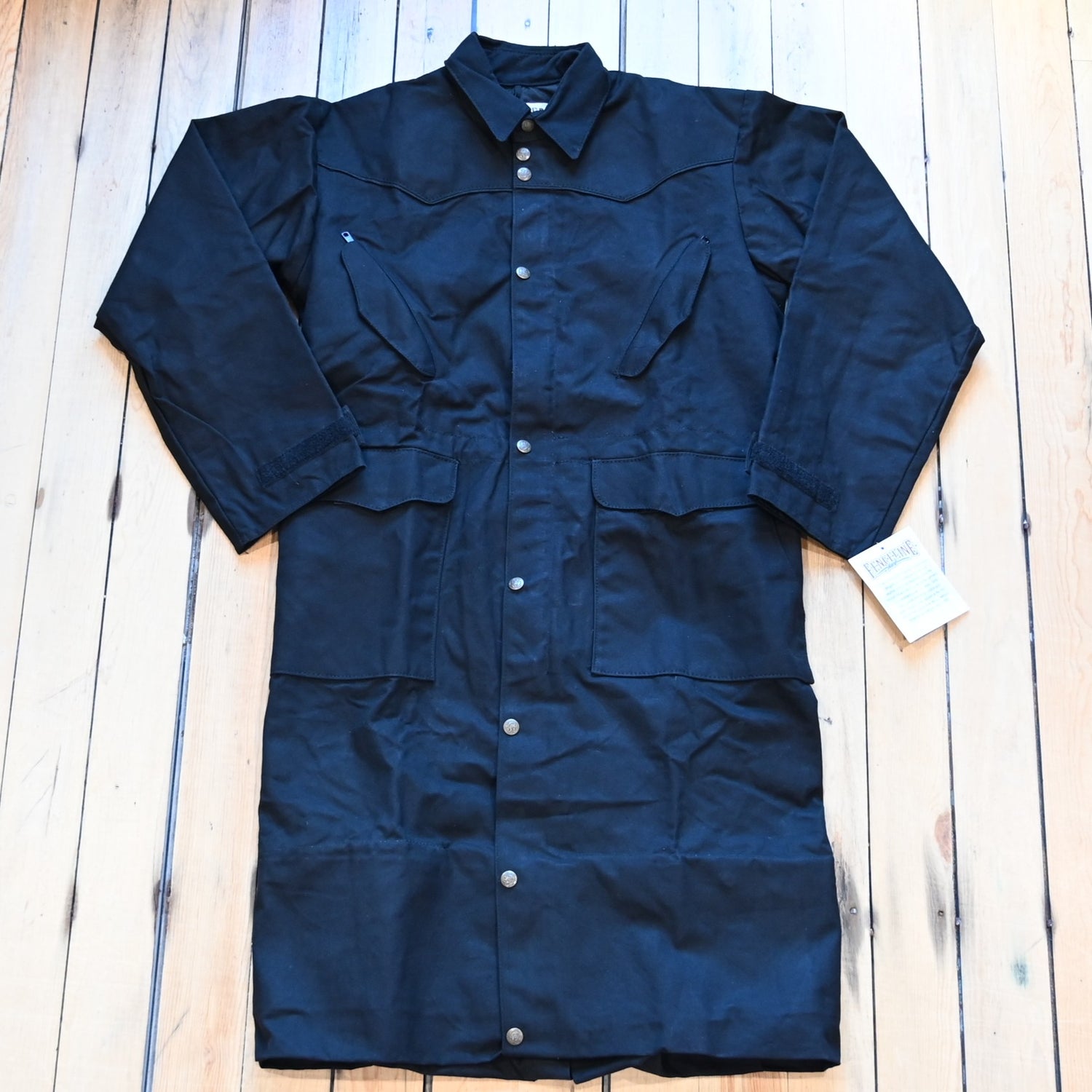 View of Black full-length Schaefer canvas duster coat with utility pockets and corduroy collar