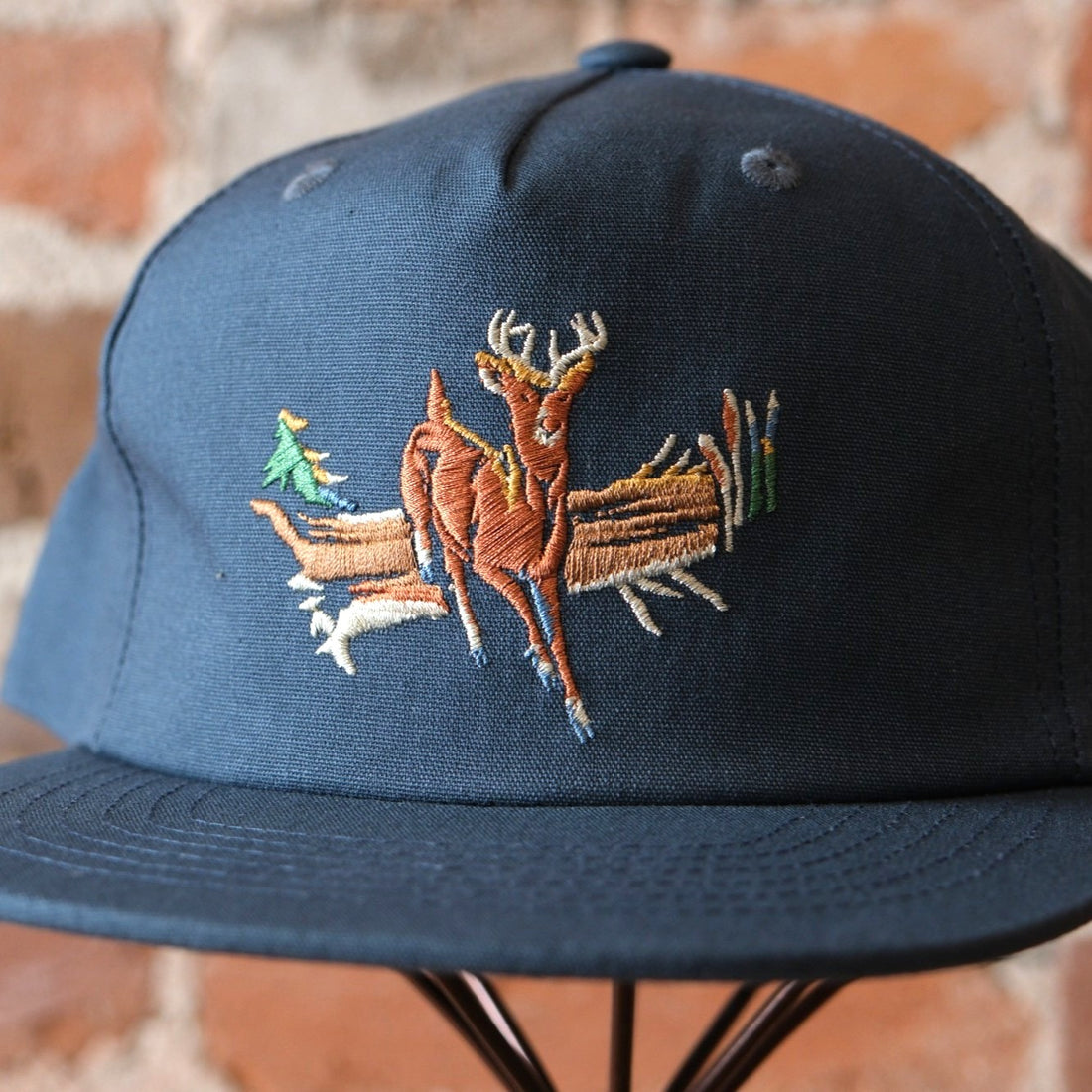 Filson Deer Trucker Cap in Dusty Blue featuring a 5-panel pinched front and custom deer embroidery.