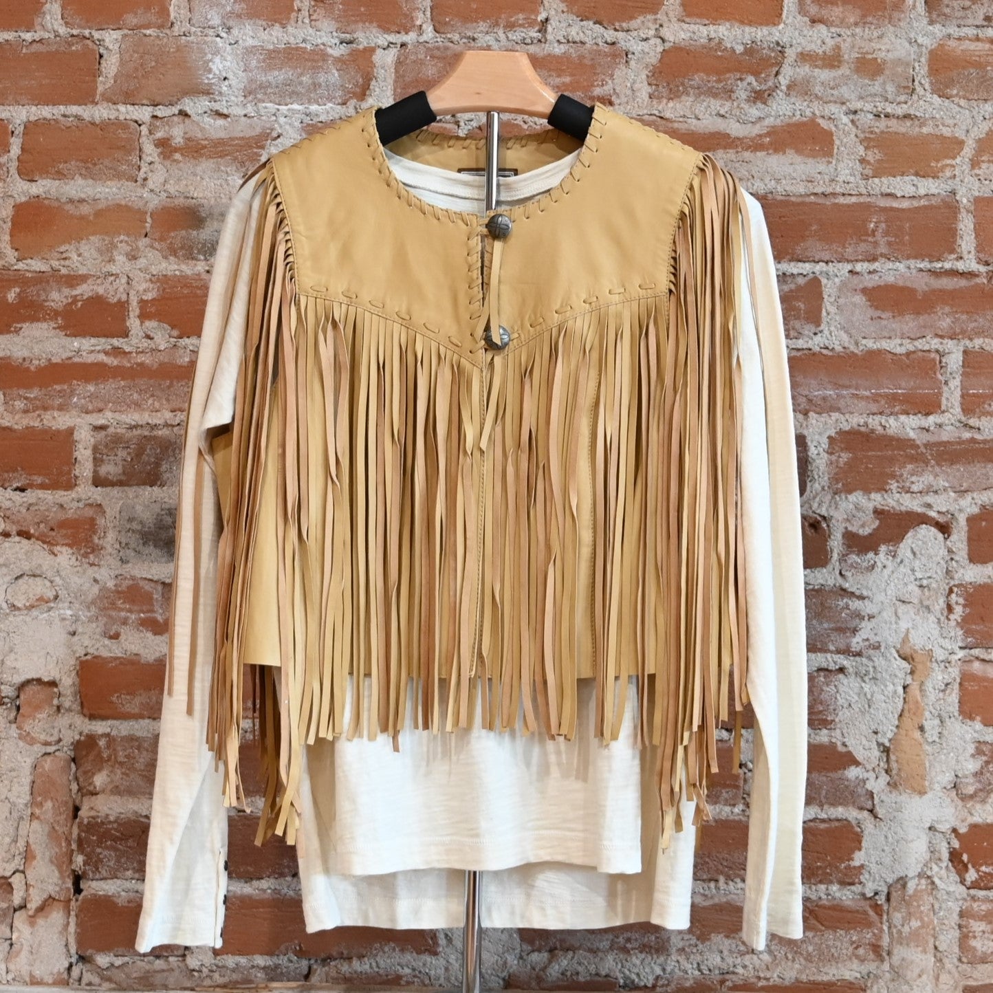 View of Double D Ranch Sonora Vest in Straw featuring full-length fringe and tonal leather lacing details