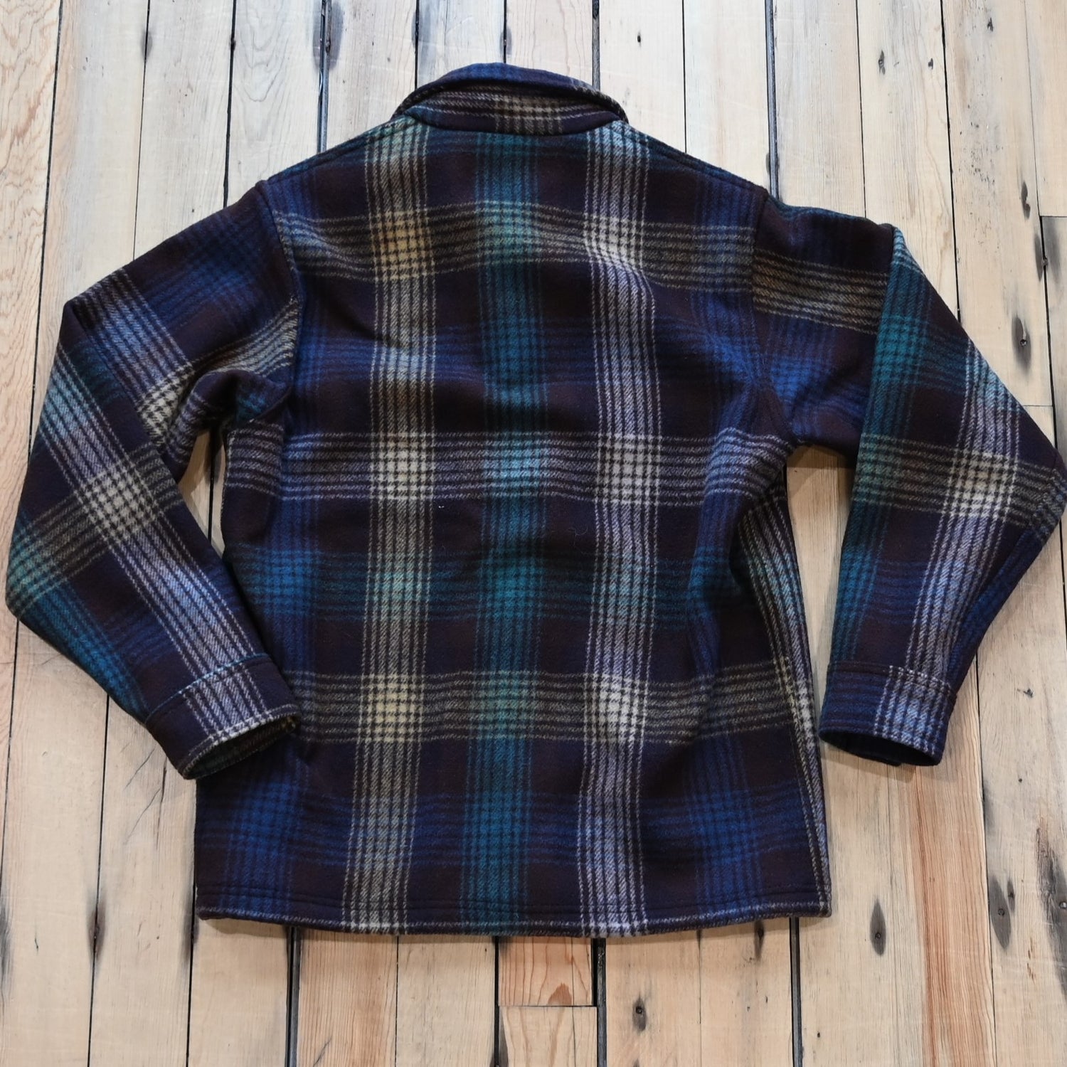 View of Filson Mackinaw Wool Jac-Shirt in Black Coffee Multi Plaid and Red/Black Ombre Plaid featuring button-front closure, adjustable cuffs, and hidden button-secured pockets