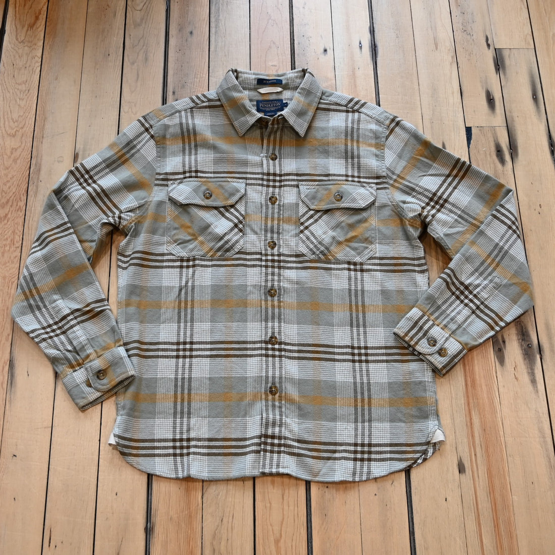 View of Plaid button-up shirt in tan, brown and grey by Pendleton Burnside style