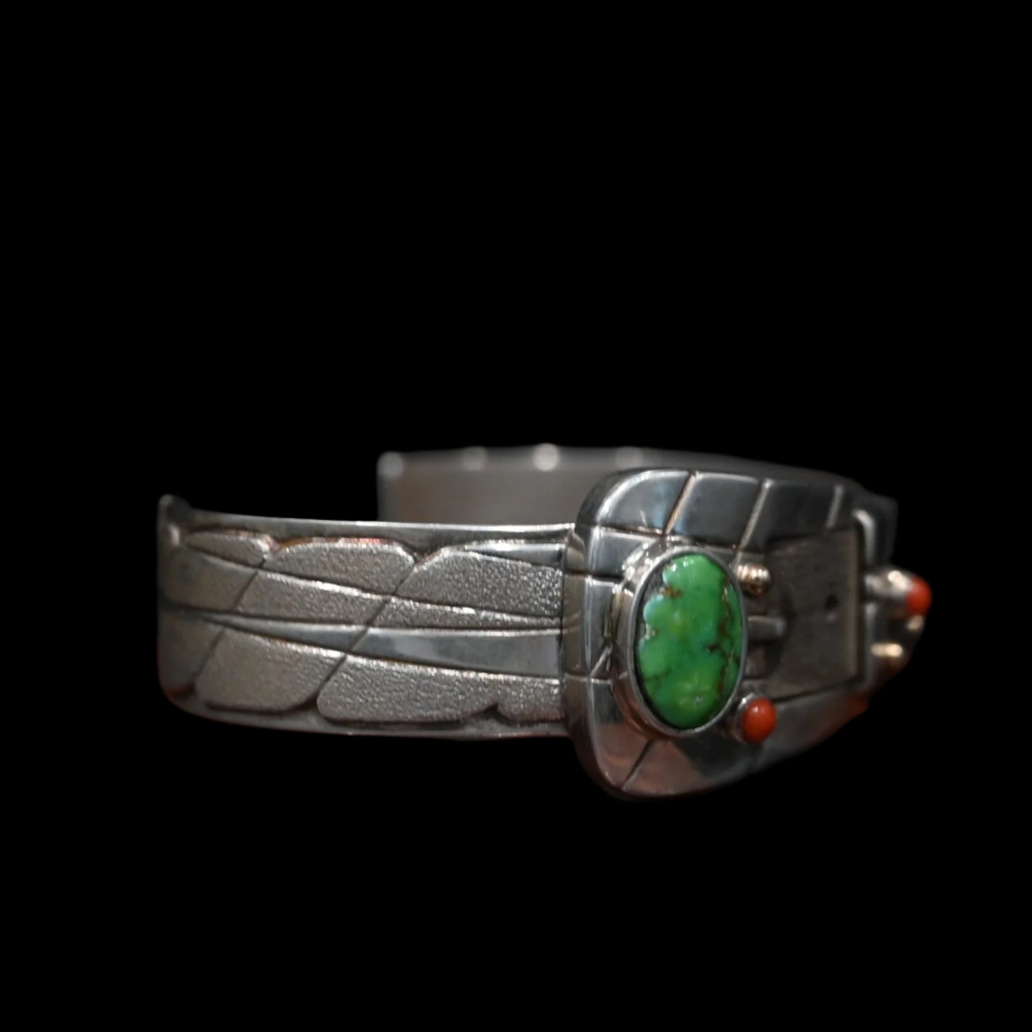 View of Sunwest Silver Carico Lake Turquoise Belt Cuff featuring a belt-like structure with a Carico Lake turquoise stone and spiny oyster stone dots set in sterling silver