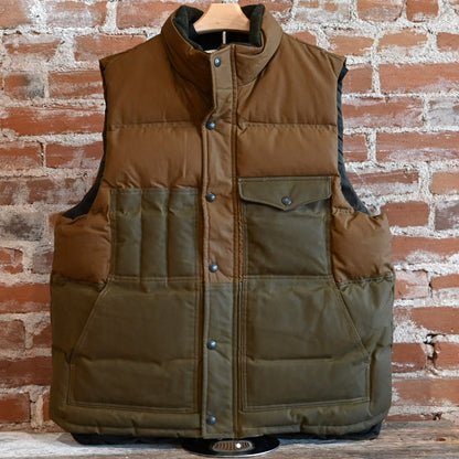 View of Filson Down Cruiser Vest in Dark Tan and Blue Coal featuring oil finish Cover Cloth and multiple pockets