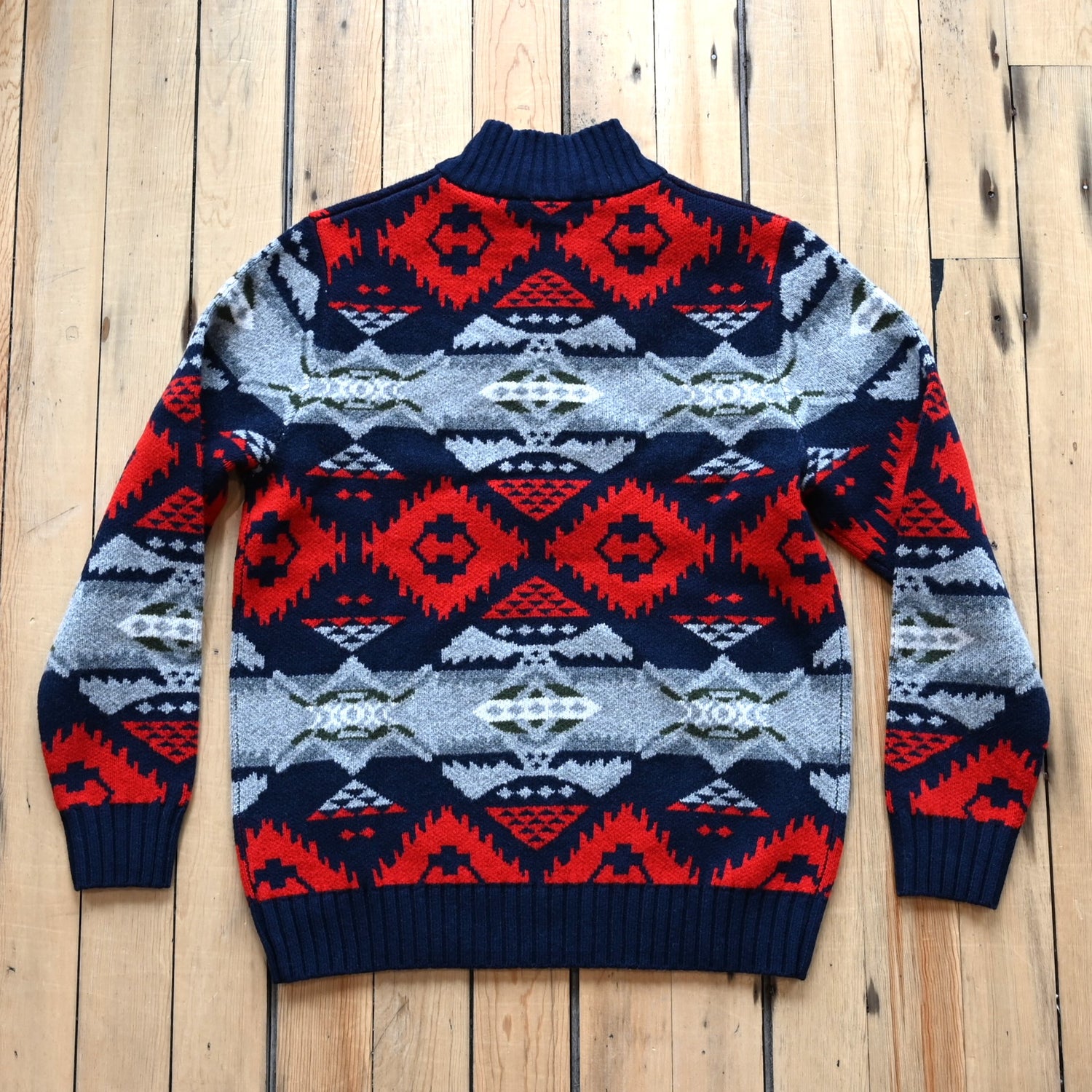 View of Pendleton men’s Nehalem lambswool ¼‑zip sweater in navy and red with geometric pattern