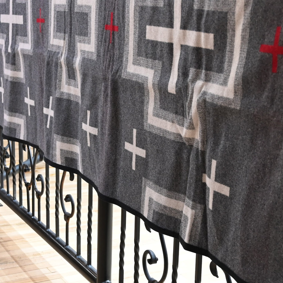 View of Pendleton San Miguel queen blanket with geometric jacquard pattern and Ultrasuede trim