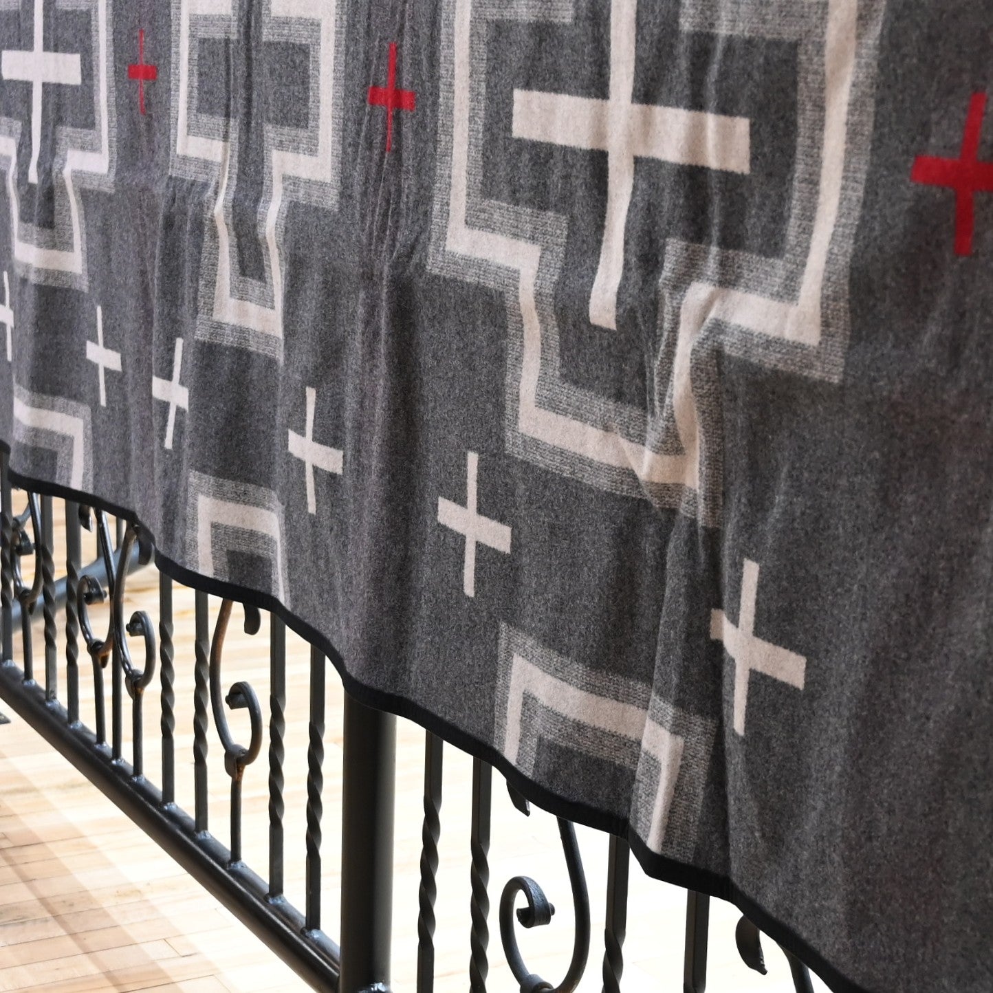 View of Pendleton San Miguel queen blanket with geometric jacquard pattern and Ultrasuede trim