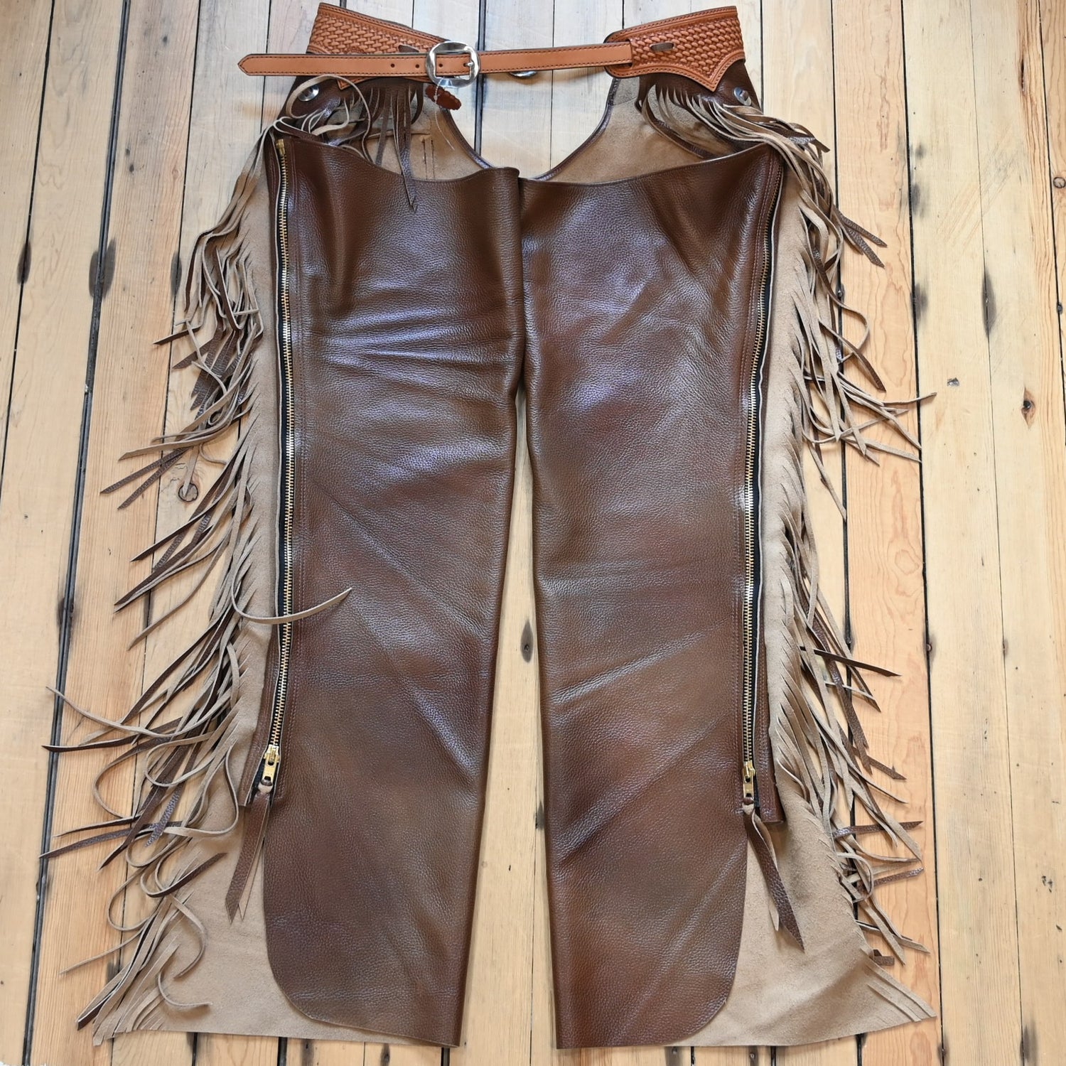 View of K Bar J Puncher Versatility Chap in Size Large with basket weave tooling and slotted conchos