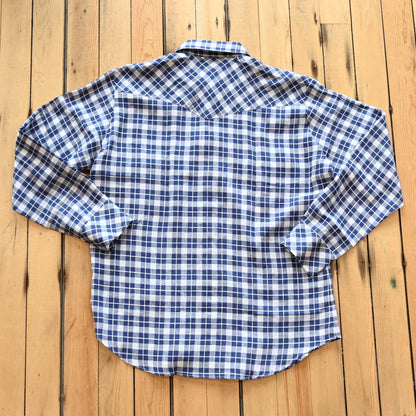 View of Blue Blanket men’s blue plaid linen Western shirt with pearl snaps and yoke detail