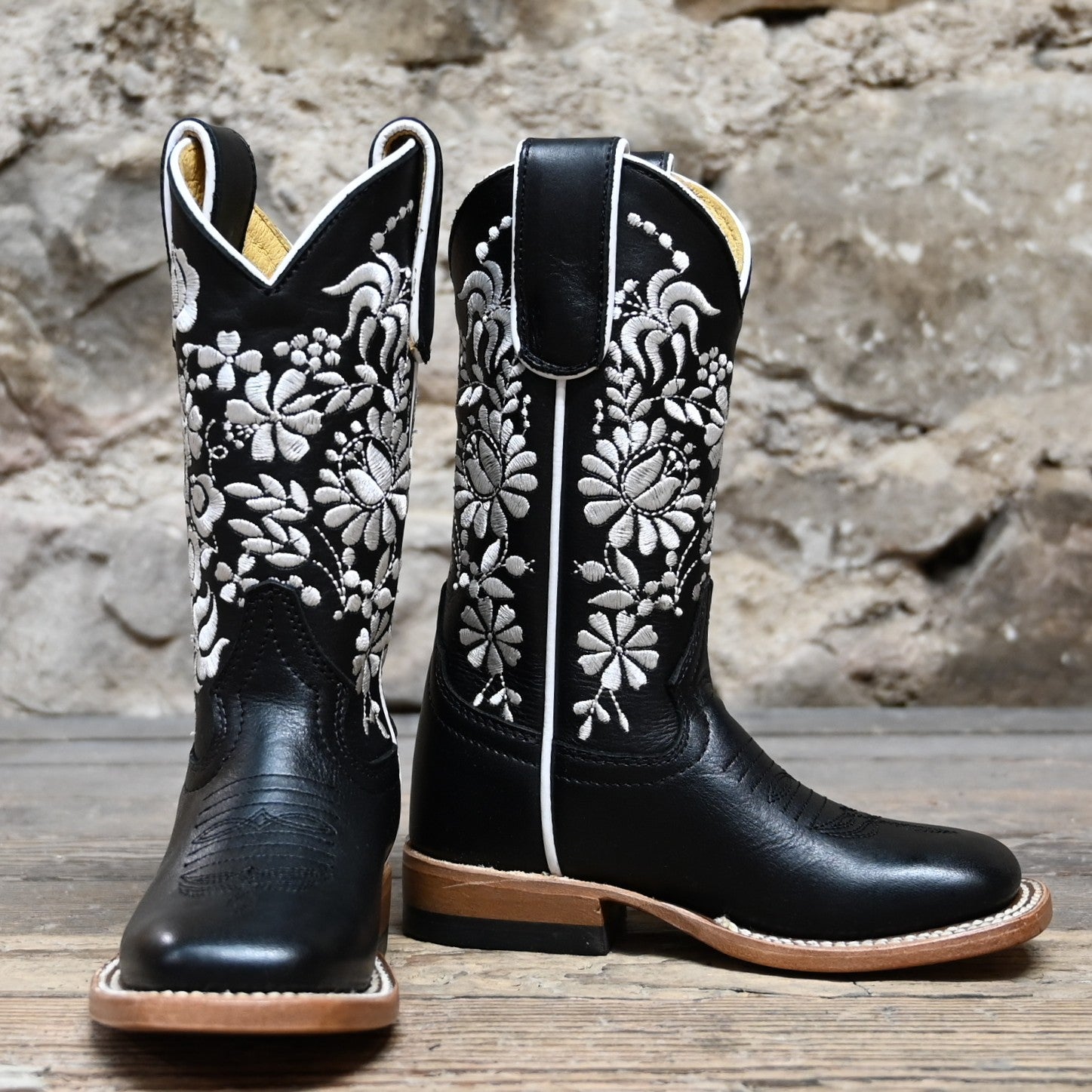 View of Macie Bean Kids Black Eyed Susan boot with black leather and white floral stitching