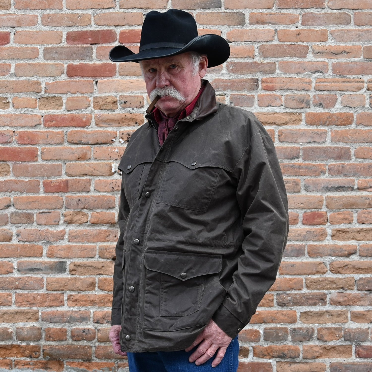 View of Schaefer oak waxed canvas High Plains Drifter jacket with leather collar and multiple pockets