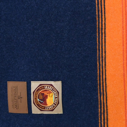 View of Pendleton National Park Blanket in Grand Canyon Navy with heritage stripes and park label