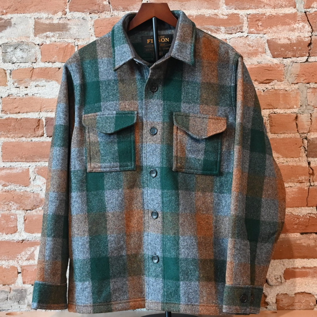 Filson Mackinaw Wool Jac-Shirt in Green, Orange, and Gray Plaid with button-front and chest pockets