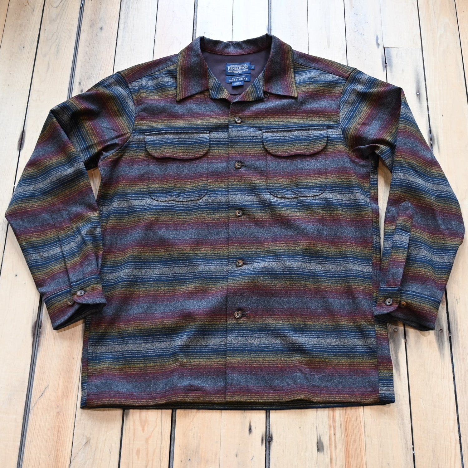 View of Pendleton men’s wool board shirt in brown multi ombré stripe with bias pockets and square hem