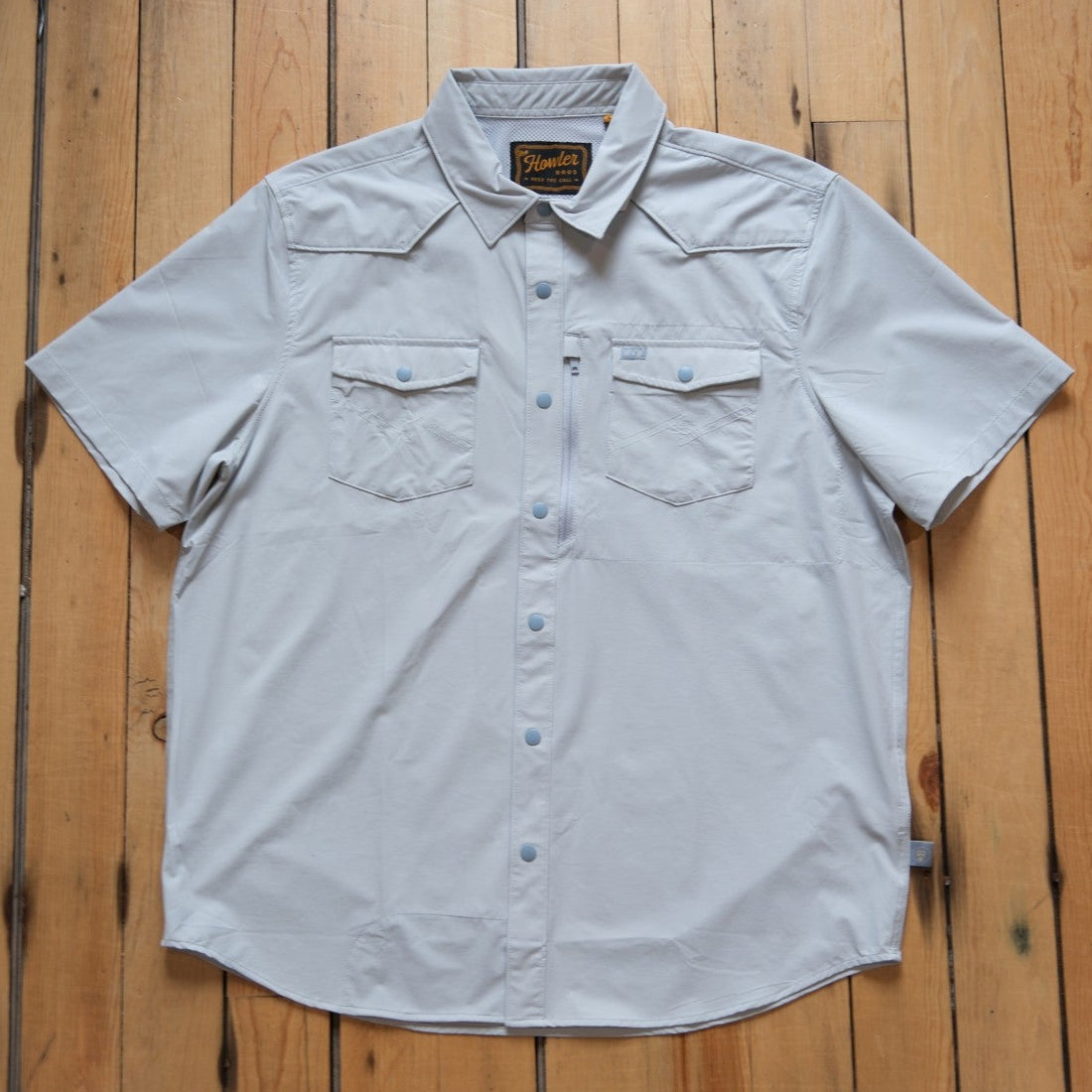 Howler Brothers Emerger Tech Shirt in Cloud grey with a vented back and snap pockets.
