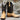 View of Hondo full quill umber ostrich boot with brown volcano top, medium round toe, and pull straps