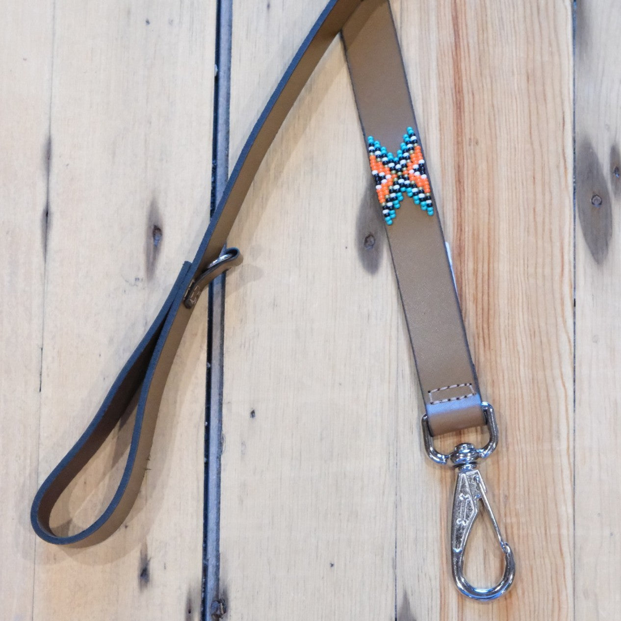 Sambboho Biarritz dog leash with turquoise, orange, white, and black beads on brown full-grain leather.