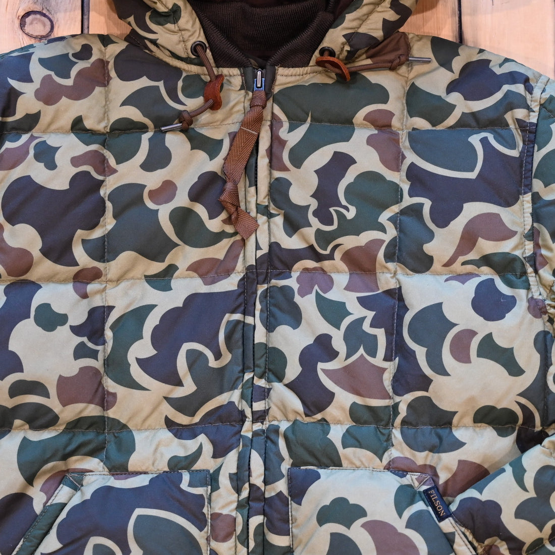 Filson Waxed Down Jacket in Tundra Shrub Camo with hood, waxed shell, and insulated down fill