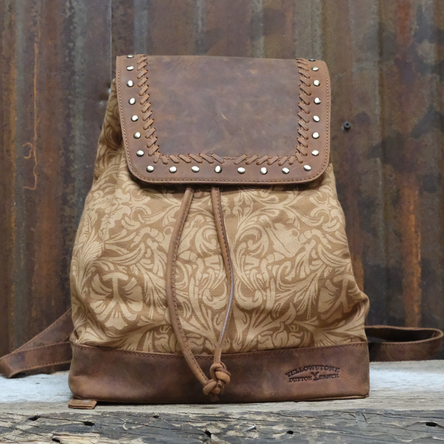 Myra Yellowstone Amber Sienna printed canvas drawstring backpack with leather trim and adjustable straps