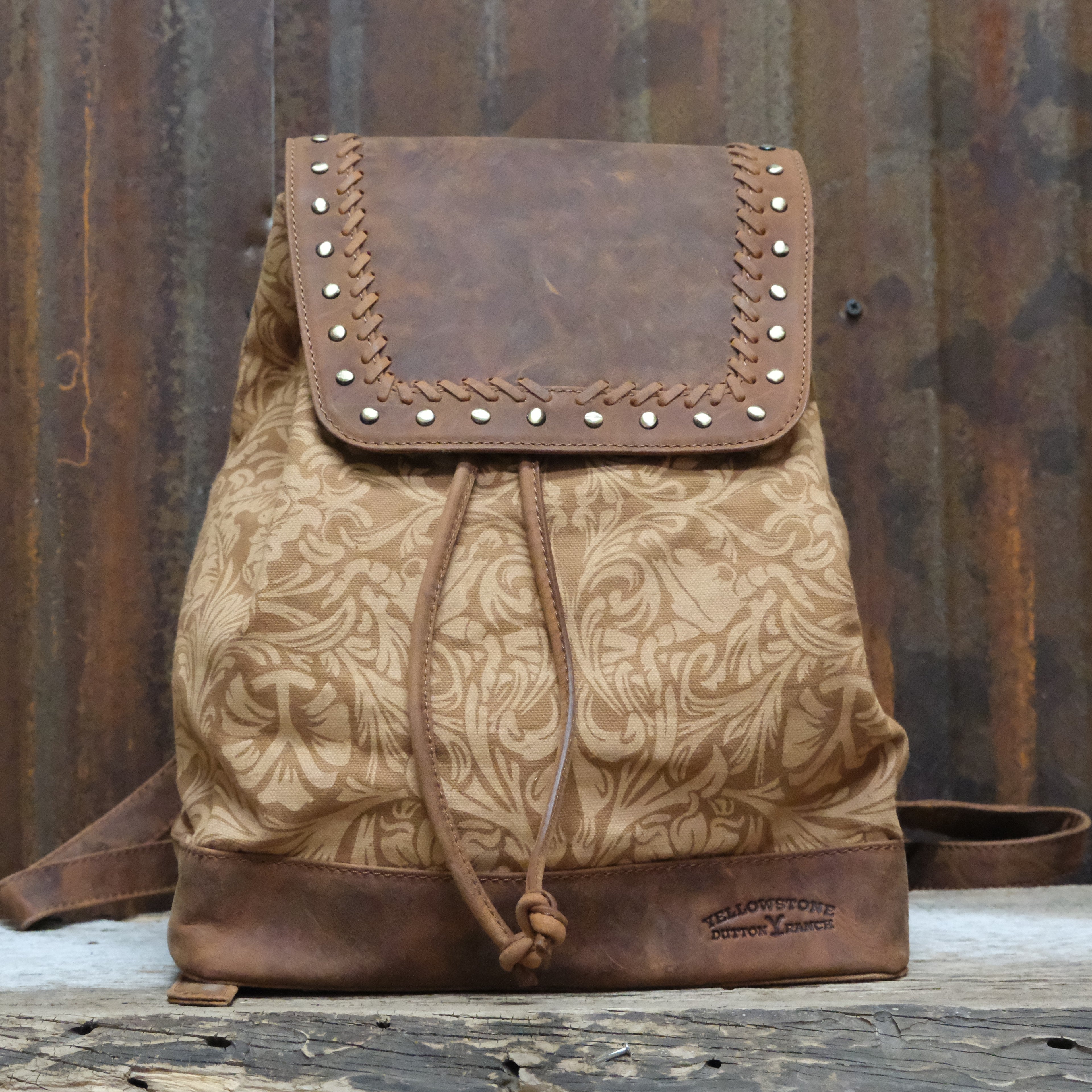 Myra Yellowstone Amber Sienna printed canvas drawstring backpack with leather trim and adjustable straps