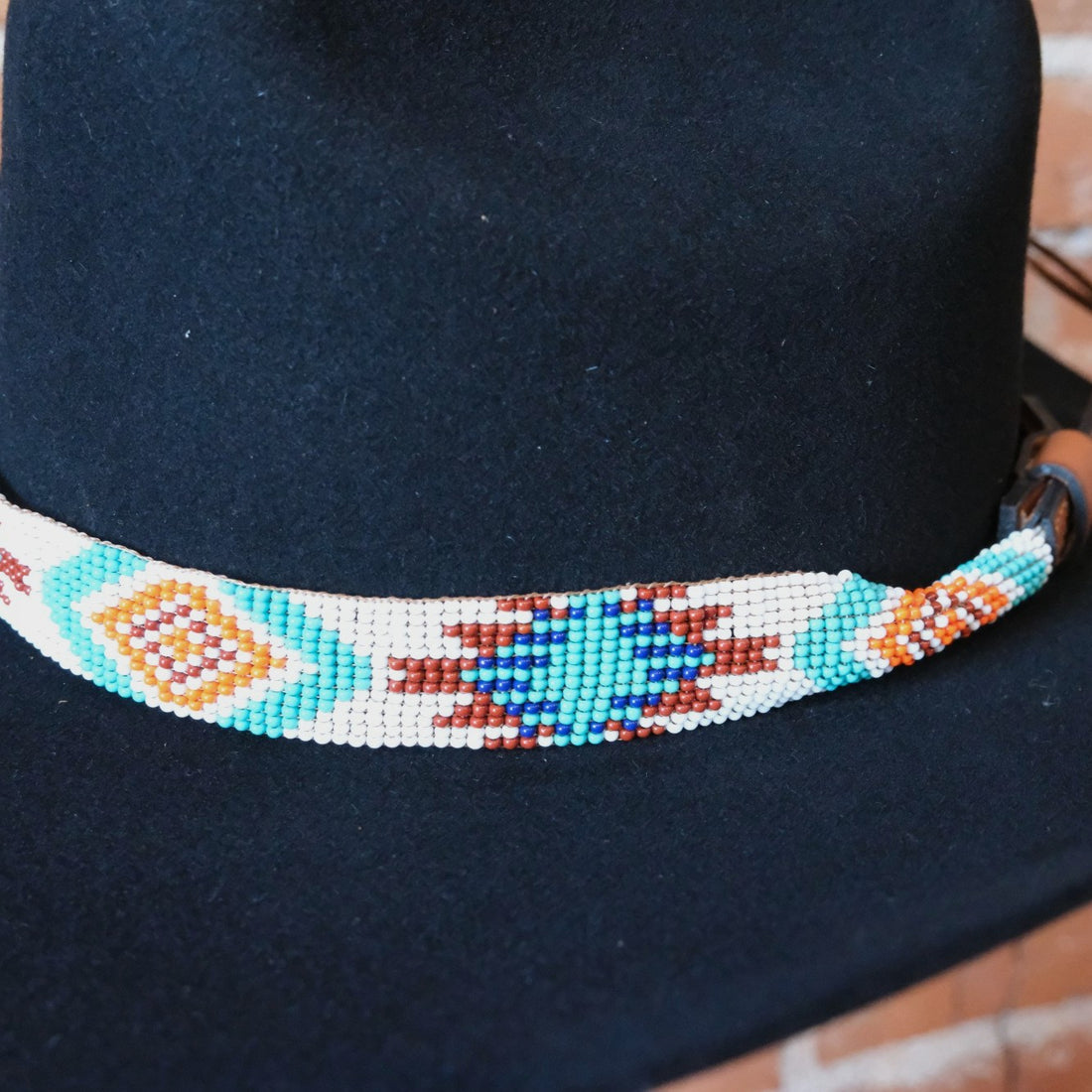 Sambboho Aztec beaded leather hatband with vibrant red, white, and turquoise native geometric patterns.