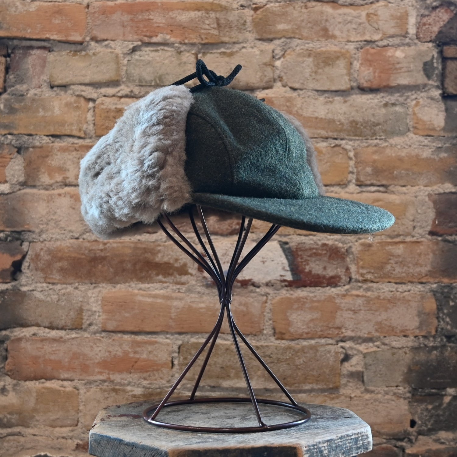 View of Filson Double Mackinaw Cap in Forest Green/Acorn and Burgundy/Dark Olive Plaid featuring shearling-lined earflaps and a 3&quot; bill