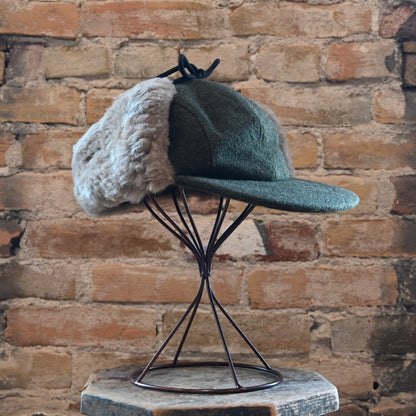 View of Filson Double Mackinaw Cap in Forest Green/Acorn and Burgundy/Dark Olive Plaid featuring shearling-lined earflaps and a 3&quot; bill