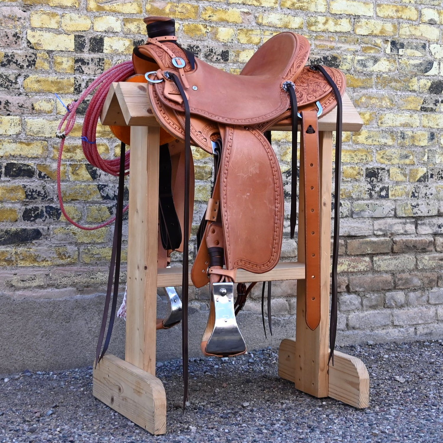 View of Deeter 3B Visalia Roughout Saddle with floral stamping and post horn