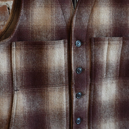 View of Filson Mackinaw Wool Vest in Brown/Tan Ombre featuring V-neckline, button-front closure, and multiple pockets